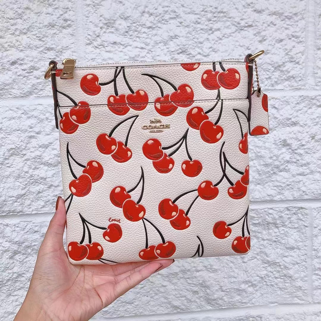 Coach CA812 Kitt Messenger Crossbody With Cherry Print In Brass/Chalk Coach CA812 Kitt Messenger Crossbody With Cherry Print In Brass/Chalk